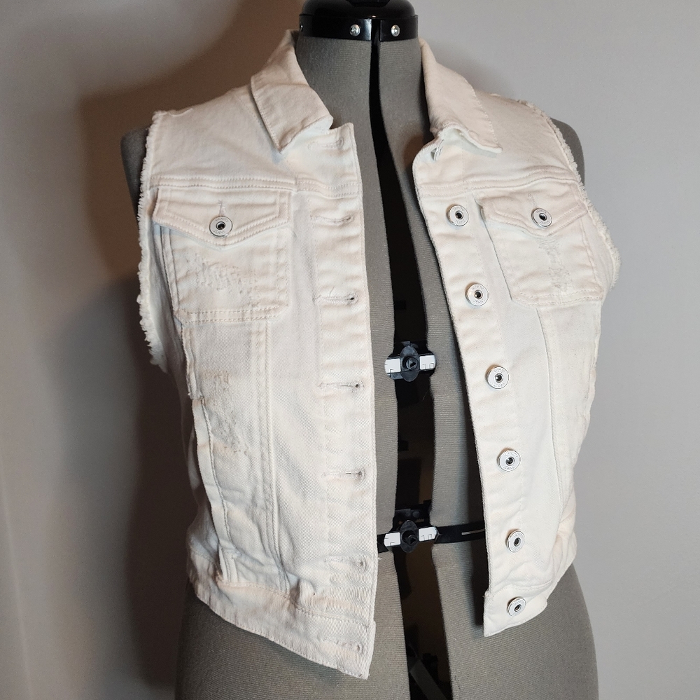 Distressed white sleeveless denim jacket